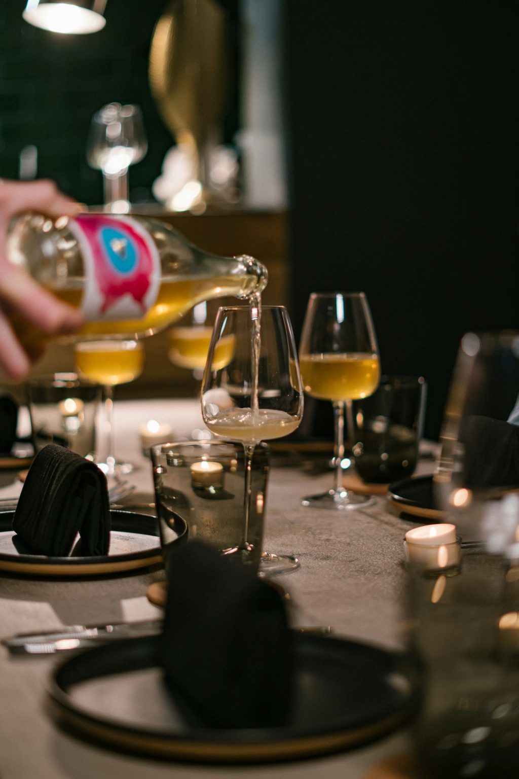 Wine poured at a candlelit dinner table